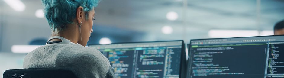 Junge Frau programmiert am Computer