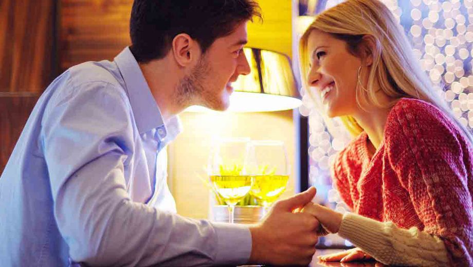 Paar händchenhaltend am Tisch vor Lampe