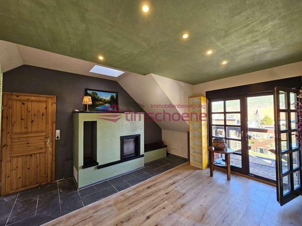 Wohnzimmer mit Kamin und Balkon